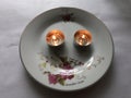 Two candles burn on a plate Royalty Free Stock Photo