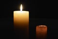 Two candles lighting the darkness on dark background Royalty Free Stock Photo