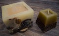 Two candles with natural ornaments on a wooden background. from coffee beans