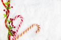 Two Candy Canes With Christmas Decoration On Snowy Background Royalty Free Stock Photo