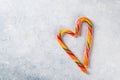 Two candy canes making a heart on grey textured background, Candy cane heart. Valentines day greeting card. Valentines Royalty Free Stock Photo