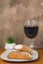 Two cannoli  with a glass of wine Royalty Free Stock Photo