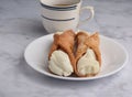 two cannolis with a cup of tea Royalty Free Stock Photo