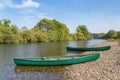 Two canoes lie on the bank of the river Royalty Free Stock Photo