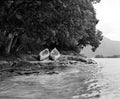Two canoes on rocky beach on edge of lake Royalty Free Stock Photo