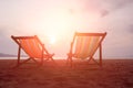 Two canvas chairs on the beach background at sunset in summer at Sai Kaew Beach, Thailand Royalty Free Stock Photo