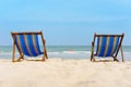 Two canvas chairs on the beach background. On white sand and blue sea so beautiful and relax  view Royalty Free Stock Photo