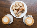 Two cappuccino cups and sliced bread