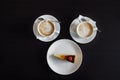 Two cappuccinos and a piece cheesecake