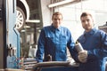 Two car experts at their workplace Royalty Free Stock Photo