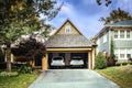 Two car garage open with two white SUVS parked inside on autumn day Royalty Free Stock Photo