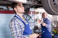 Two car mechanics at workshop Royalty Free Stock Photo