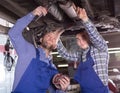 Two car mechanics at workshop Royalty Free Stock Photo