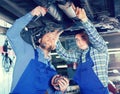 Two car mechanics at workshop Royalty Free Stock Photo