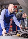 Two car mechanics at workshop Royalty Free Stock Photo