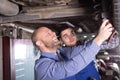 Two car mechanics at workshop Royalty Free Stock Photo