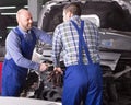 Two car mechanics at workshop Royalty Free Stock Photo