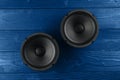 Two car musicl speakers, car speaker audio on blue wooden background Royalty Free Stock Photo