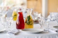 two carafes with lemonades on the table