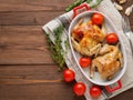 Two carcasses fried chicken in a bowl, baked chucks in an oven w