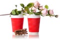 Two cardboard coffee cups chocolate flowers Royalty Free Stock Photo