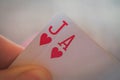 Two cards ace and jack of hearts, Playing cards in hand on the table, poker nands Royalty Free Stock Photo