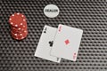 Two cards with red poker chips and the dealer chip Royalty Free Stock Photo