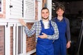 Two careful workmen inspecting windows Royalty Free Stock Photo