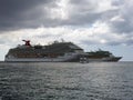 Two Carnival cruise ships and the transfer tour boat image near the harbour pier of Georgetown, Grand Cayman, Cayman Islands