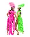 Two carnival dancer women dancing against isolated white background