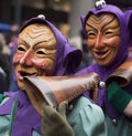 Two carnival goers wearing wooden masks