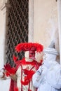 The two carnival masks discussing near the gate. Royalty Free Stock Photo