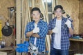 Two Carpenter showing thumb up. Young male carpenter working wood workshop Royalty Free Stock Photo