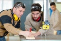 two carpenters talking while working Royalty Free Stock Photo