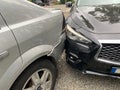 Two cars collided in a parking lot. Small gap from bumper to headlight. The cars are very close to each other. Concept: Road Royalty Free Stock Photo
