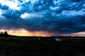 Two cars at dusk crossing the fields Royalty Free Stock Photo