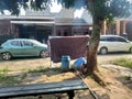 two cars parked and a clothesline in front of a neighbor& x27;s house Royalty Free Stock Photo