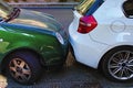 Two cars are parked very close. Two cars next to each other. Small clearance between car bumpers. Problems with parking in big Royalty Free Stock Photo