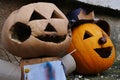 Two carved smiling halloween Jack-O-Lanterns, left one with hands made of empty toilet paper rolls Royalty Free Stock Photo