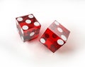 Two casino red dices in action, on white surface. Royalty Free Stock Photo