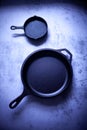 Cast iron skillets displayed on a cool grey countertop