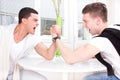 Two casual men arm wrestling Royalty Free Stock Photo