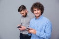 Two casual men using smartphone Royalty Free Stock Photo