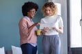 Two casual young business women working with the digital tablet in the new office Royalty Free Stock Photo