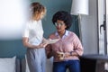 Two casual young business women working with the digital tablet in the new office Royalty Free Stock Photo