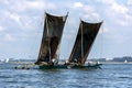 Two catamarans with giant sails sit off the coast of Negombo on the west coast of Sri Lanka.