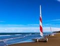 Two catamarans with red and white sails, standing on the beach sand. Royalty Free Stock Photo