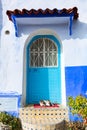 Two Cats in front of a Blue Door in Chefchaouen Morocco Royalty Free Stock Photo