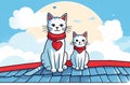 Two cats with a scarf on the neck are sitting on the roof at daytime Royalty Free Stock Photo