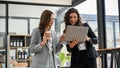 Two Caucasian businesswomen discussing and brainstorming on a project together Royalty Free Stock Photo